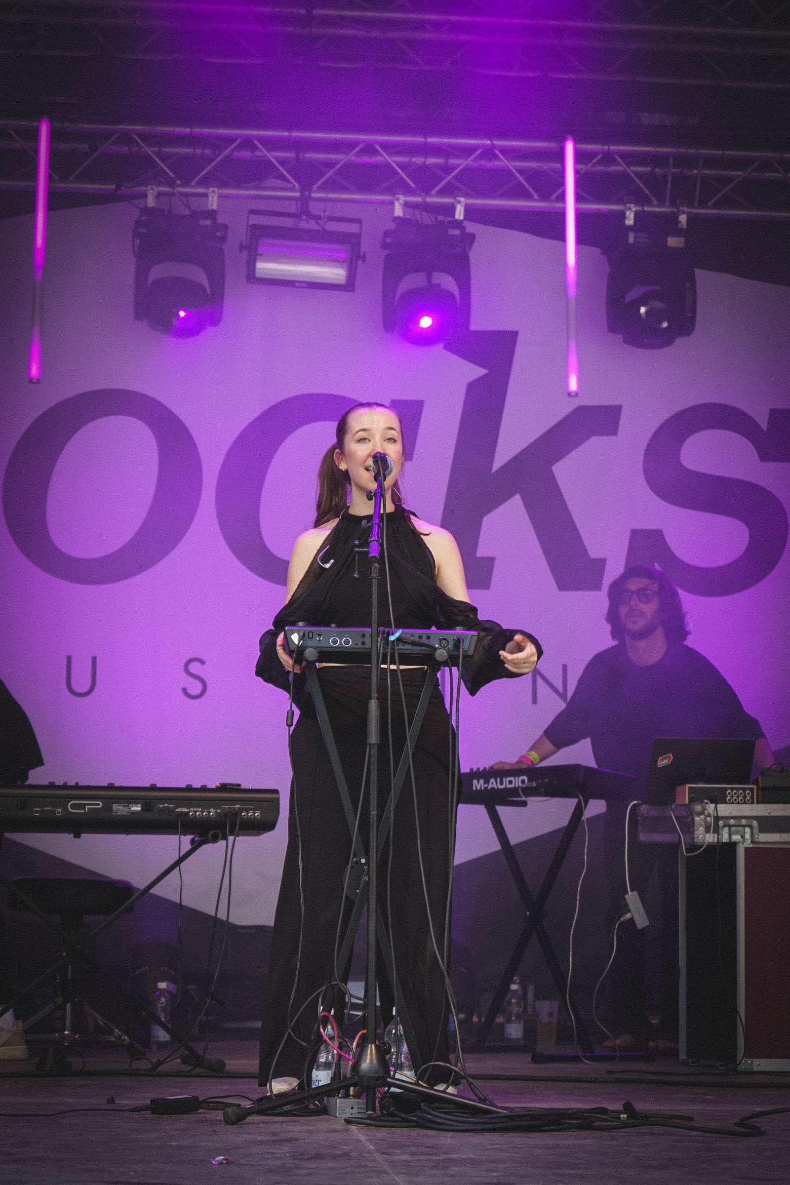 Alice Ballinari performing live under purple stage lights